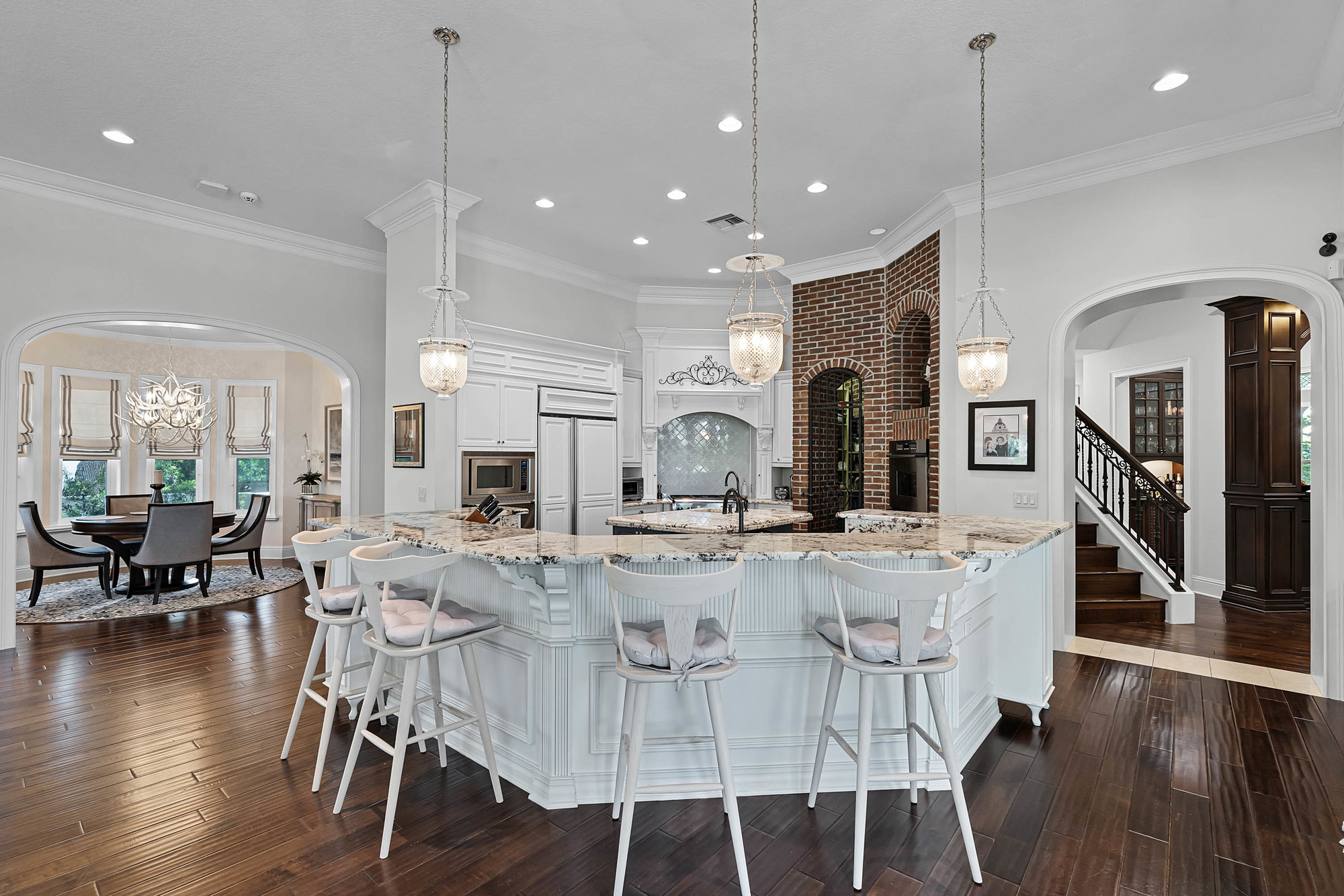 kitchen with large curved island and bar chairs